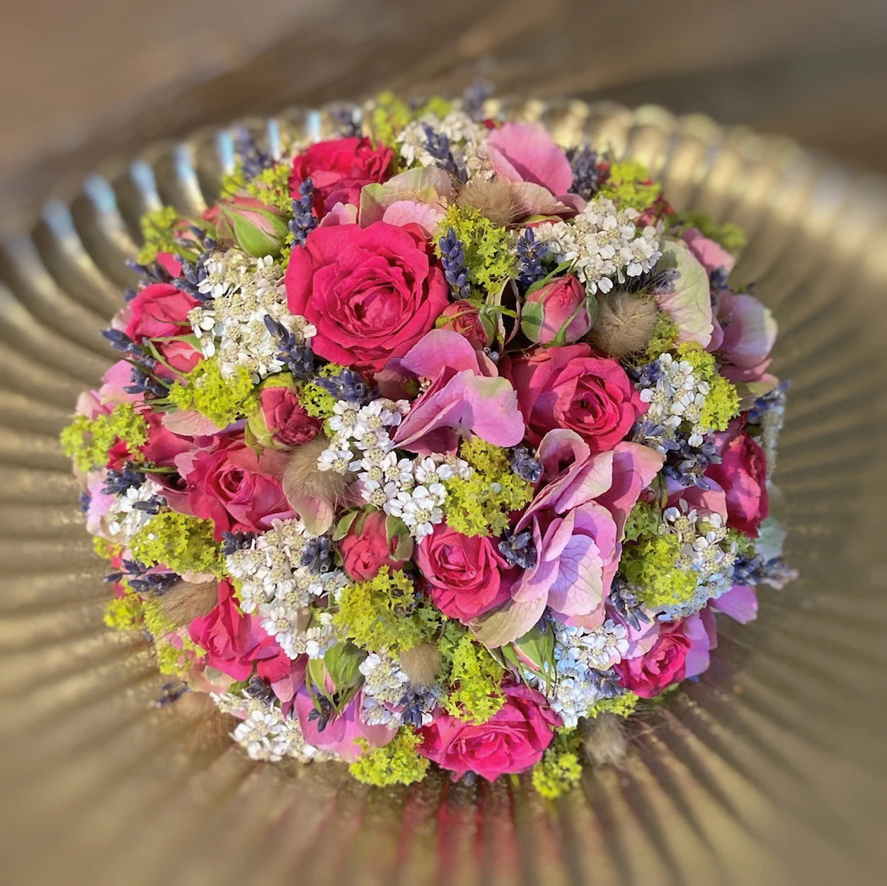 Kugelförmiges Blumengesteck mit dichter Blütenstruktur – florale Gestaltung in klarer Form