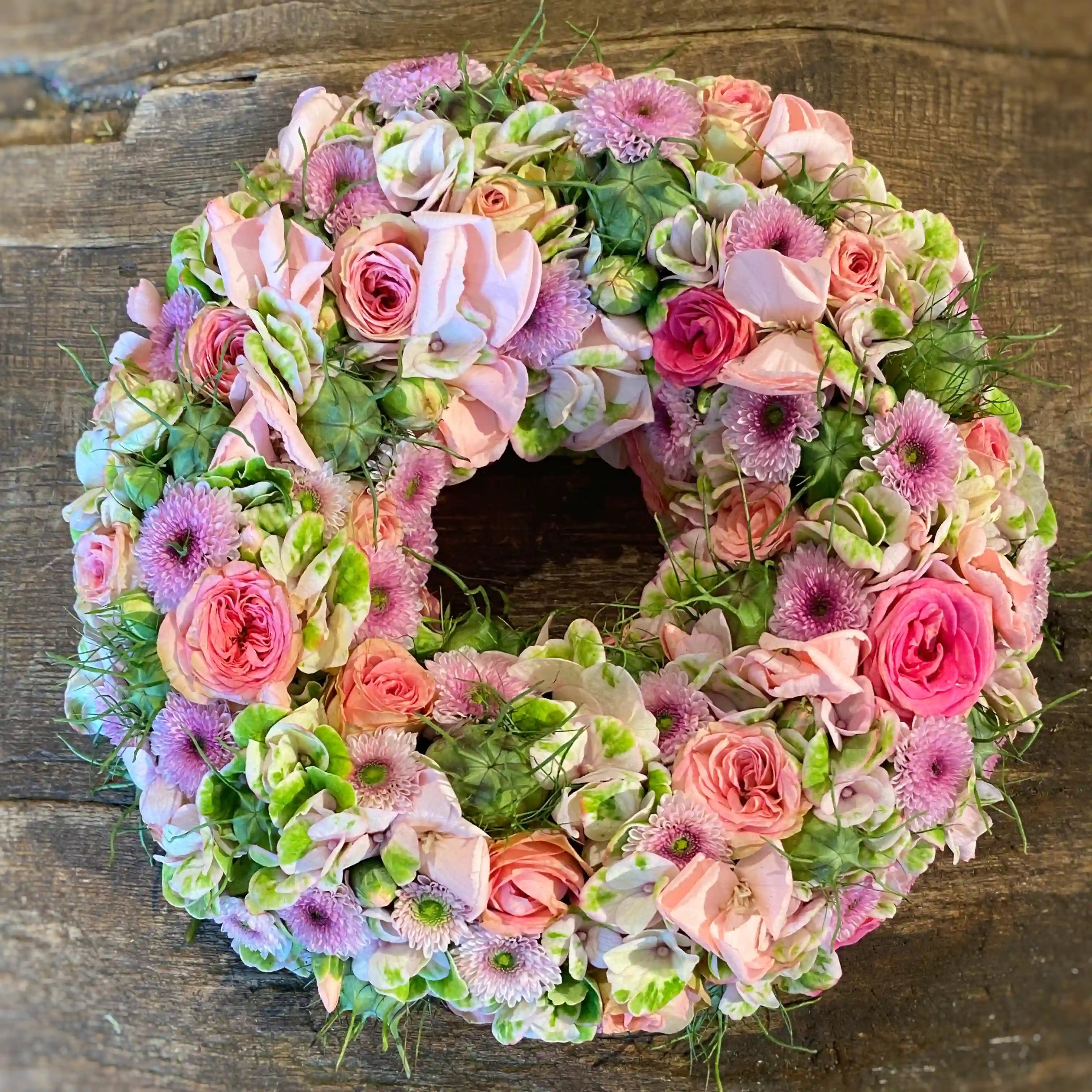 Kreisförmiger Blumenkranz mit dichter Blütenstruktur – florale Gestaltung mit zeitloser Anmutung